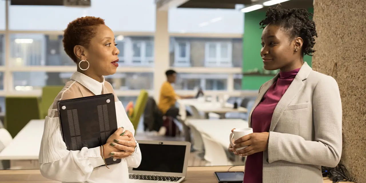 Two people networking at an event and investing in their connections