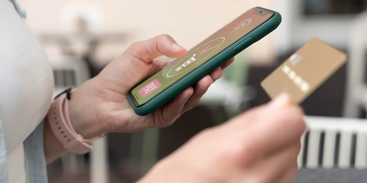 Professional using NFC card as digital business card to share your contact information.