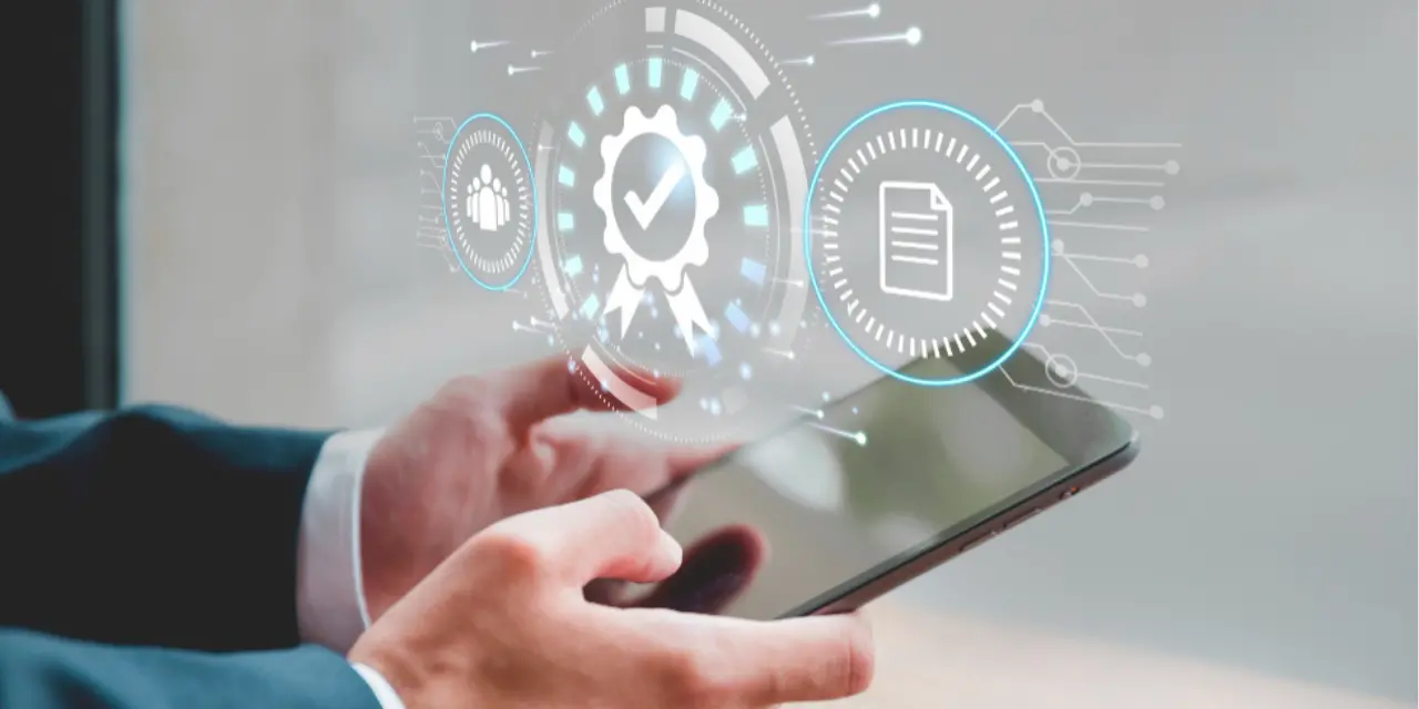 Hands holding a tablet with floating digital icons on the screen.